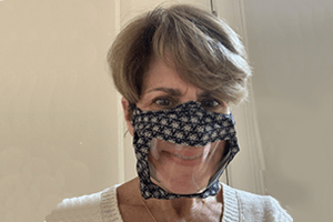 Dr. Debara Tucci wearing a clear face mask.